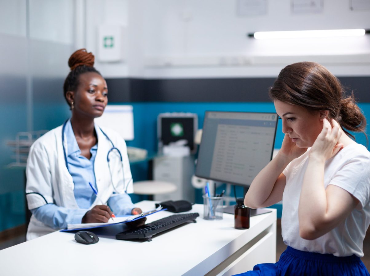 General practitioner doctor consulting patient with sore, hurt, aching painful neck nape symptoms. Healthcare specialist medical appointment check-up in modern clinic office