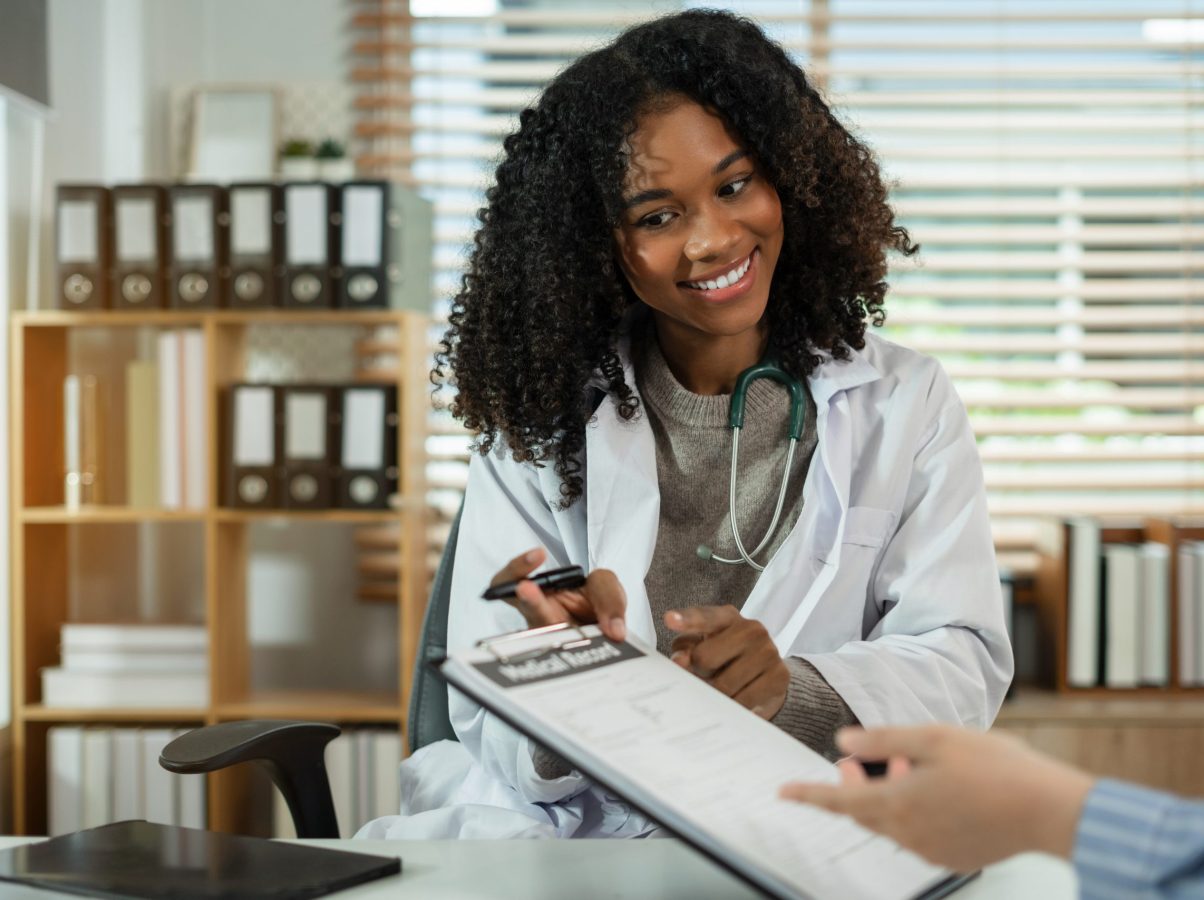 patient filling insurance legal document at appointment with doctor.  patient signing medical treatment contract, agreement form for taking medic care service, consultation, therapy