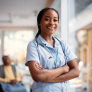 Portrait of confident African American nurse at residential care home looking at camera. Copy space.