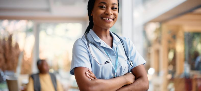 Portrait of confident African American nurse at residential care home looking at camera. Copy space.