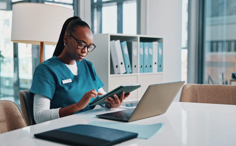 Black woman, doctor and typing with tablet at hospital for research, laboratory results and medical.