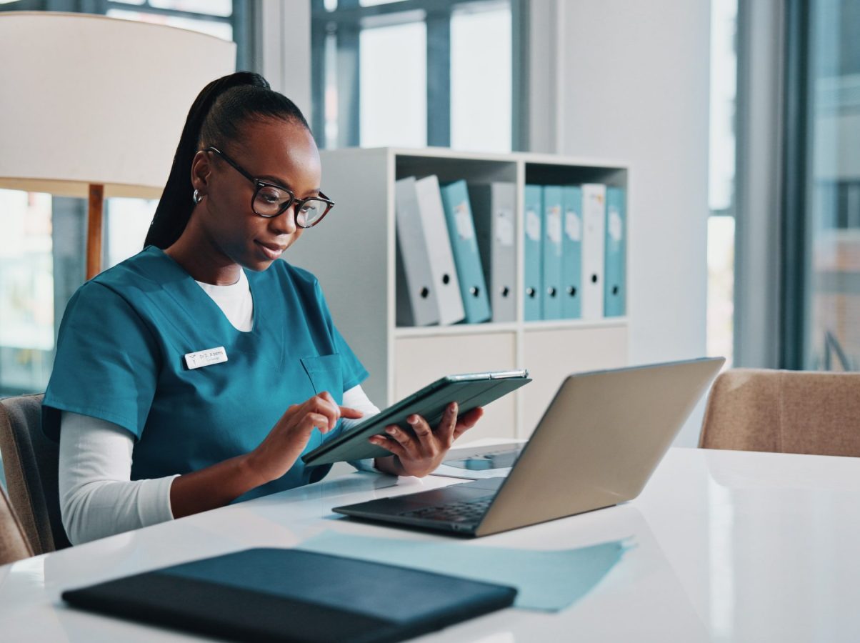 Black woman, doctor and typing with tablet at hospital for research, laboratory results and medical.